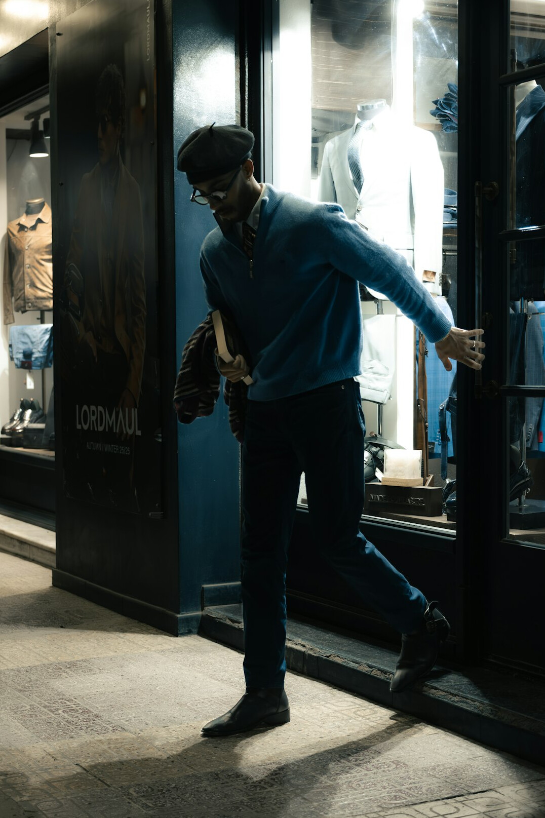man trying on jacket in clothing store