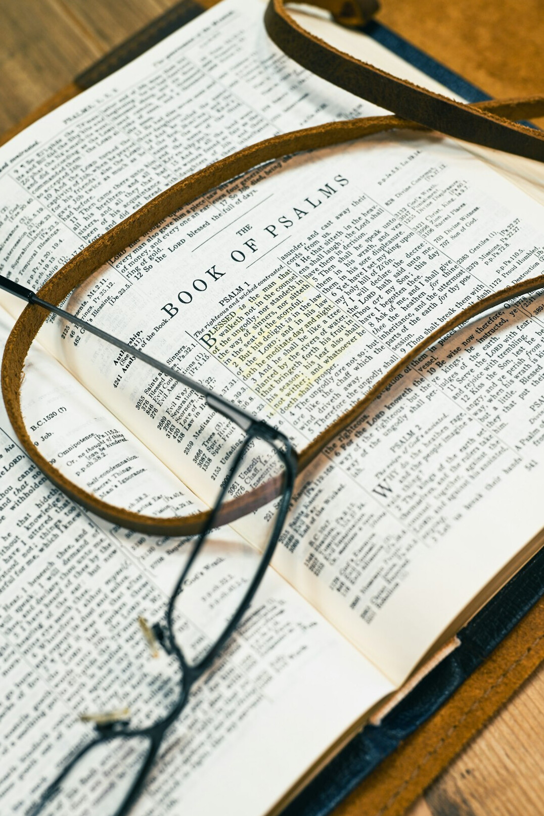 Magnifying glass resting on an open leather notebook