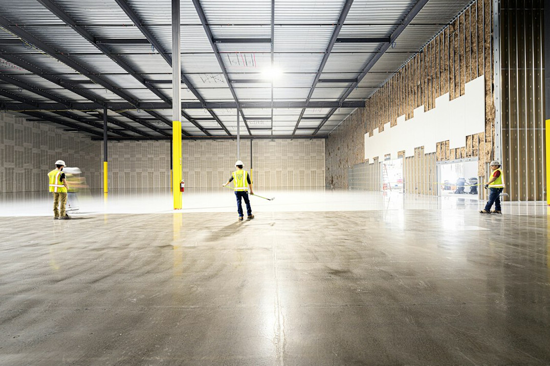 security guard patrolling warehouse at night